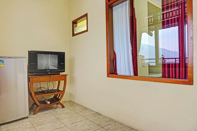 Imagen de la habitación del Hotel Capital O 92867 Villa Raggal. Foto 20