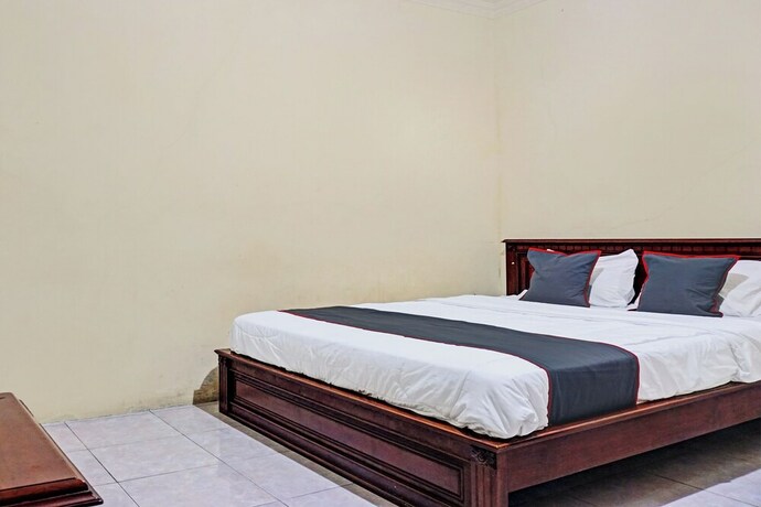 Imagen de la habitación del Hotel Capital O 92867 Villa Raggal. Foto 22