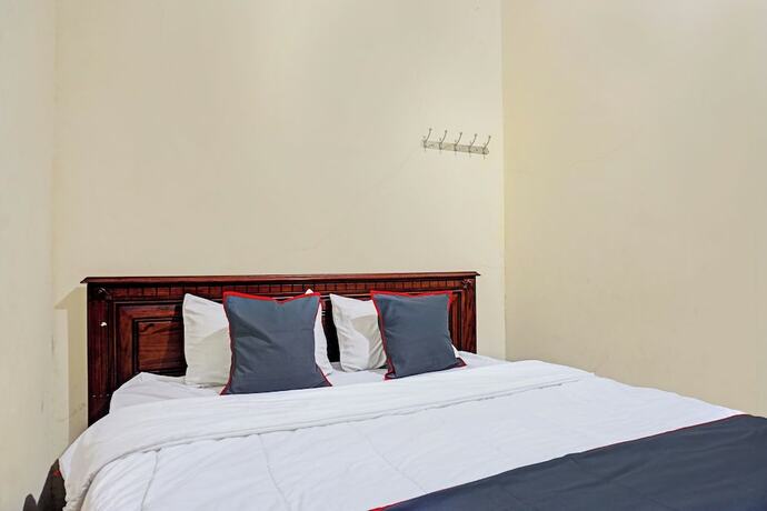 Imagen de la habitación del Hotel Capital O 92867 Villa Raggal. Foto 23