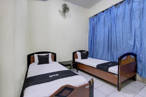 Imagen de la habitación del Hotel Capital O 93024 Ganesha. Foto 18