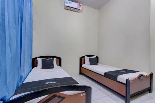 Imagen de la habitación del Hotel Capital O 93024 Ganesha. Foto 19
