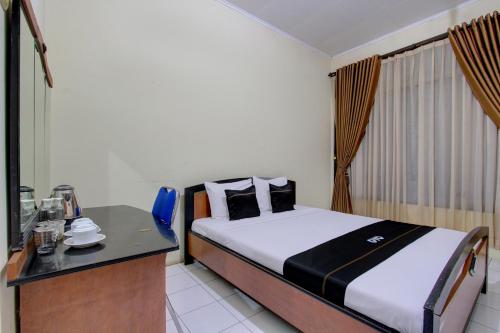 Imagen de la habitación del Hotel Capital O 93024 Ganesha. Foto 20