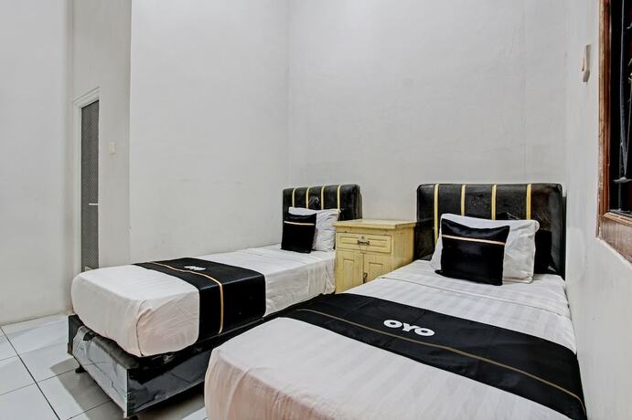 Imagen de la habitación del Hotel Capital O 93361 Dynasty Inn Syariah. Foto 18