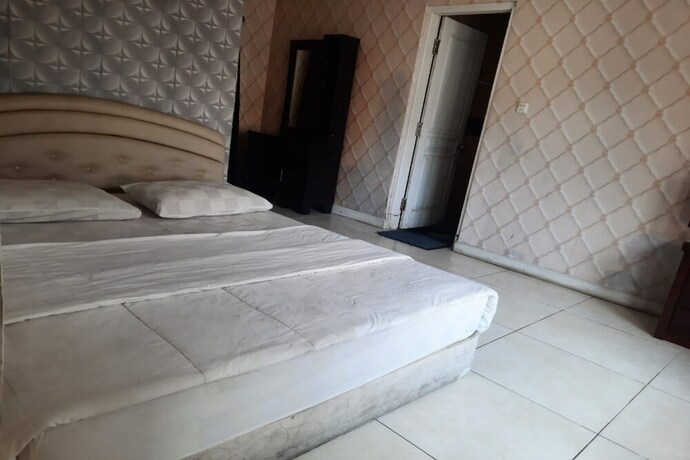Imagen de la habitación del Hotel Capital O 93529 September House. Foto 21