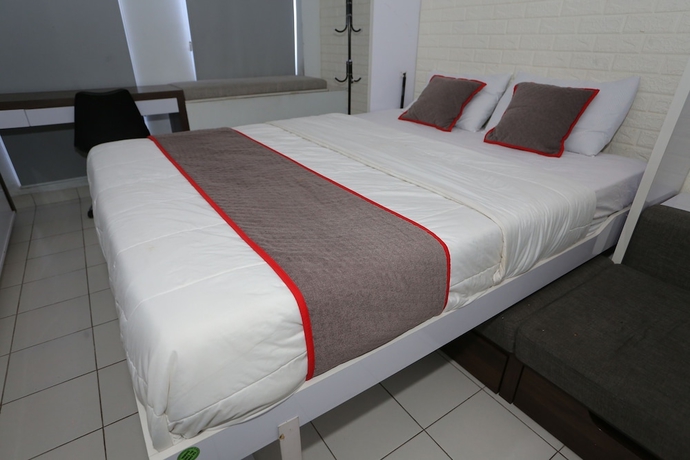 Imagen de la habitación del Hotel Capital O 93594 Pelangi Urbano. Foto 5