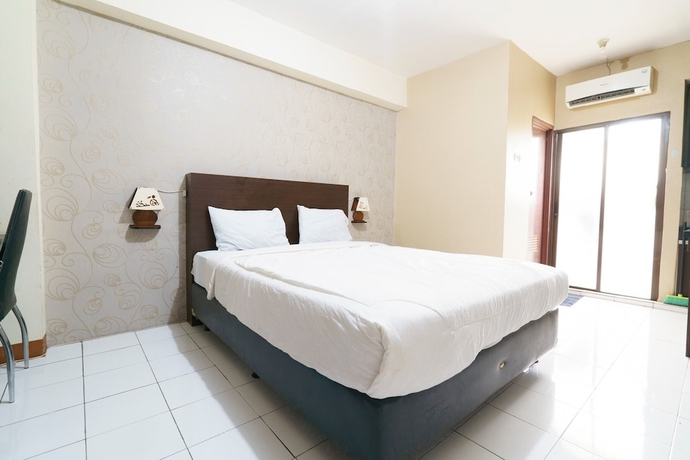 Imagen de la habitación del Hotel Capital O 93760 Apartemen Gateway Cicadas By Jh Group. Foto 2