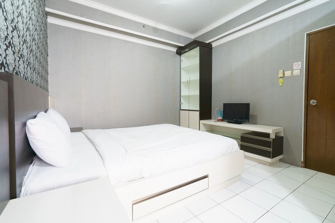 Imagen de la habitación del Hotel Capital O 93760 Apartemen Gateway Cicadas By Jh Group. Foto 12