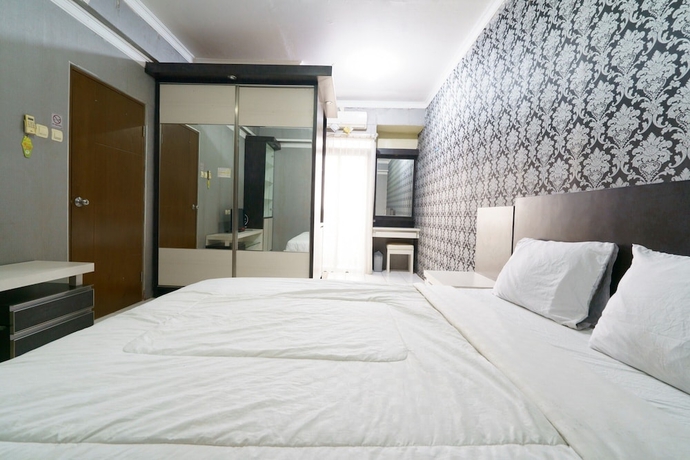 Imagen de la habitación del Hotel Capital O 93760 Apartemen Gateway Cicadas By Jh Group. Foto 13