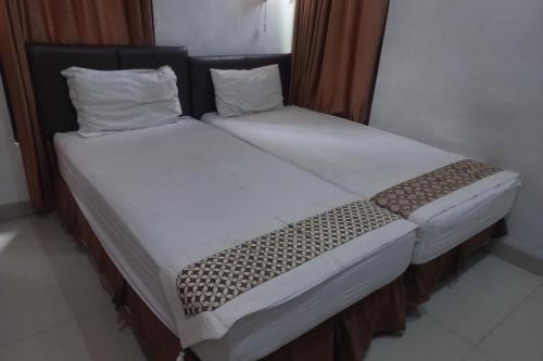 Imagen de la habitación del Hotel Capital O 93872 Natura Guest House Syariah. Foto 18
