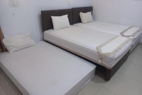 Imagen de la habitación del Hotel Capital O 93872 Natura Guest House Syariah. Foto 19