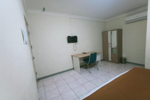 Imagen de la habitación del Hotel Capital O 94156 Gemudi Gold Islami. Foto 16