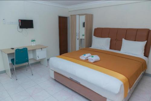 Imagen de la habitación del Hotel Capital O 94156 Gemudi Gold Islami. Foto 17