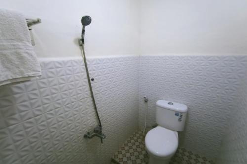 Imagen de la habitación del Hotel Capital O 94156 Gemudi Gold Islami. Foto 18