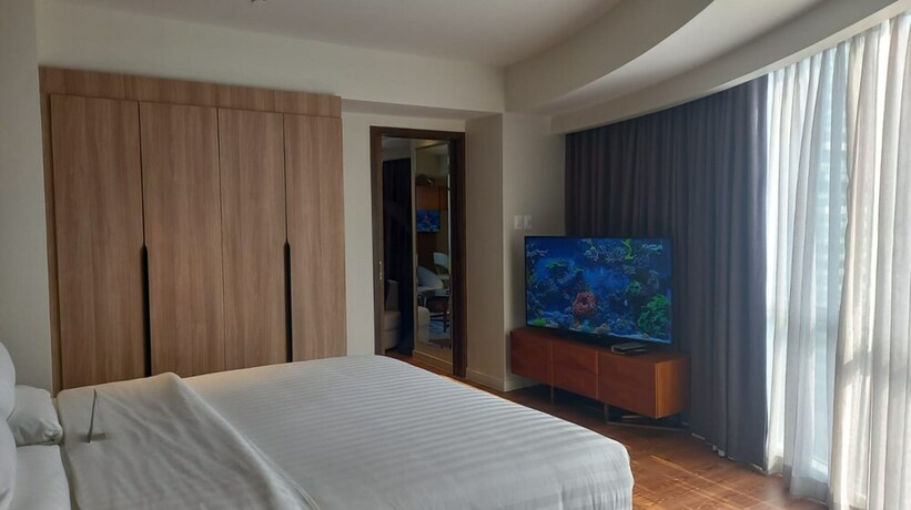 Imagen de la habitación del Hotel Capital O 950 Acqua Novotel Tower. Foto 19