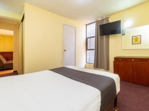 Imagen de la habitación del Hotel Capital O Suites Marne Cdmx. Foto 19