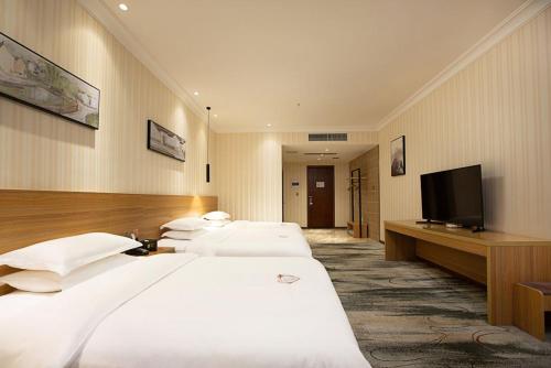 Imagen de la habitación del Hotel 海菲酒店 郑州高铁东站CbD国际会展中心店. Foto 14