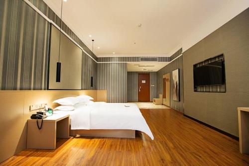 Imagen de la habitación del Hotel 海菲酒店 郑州高铁东站CbD国际会展中心店. Foto 15