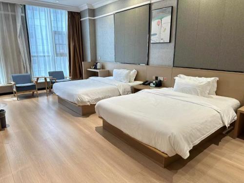 Imagen de la habitación del Hotel 海菲酒店 郑州高铁东站CbD国际会展中心店. Foto 17