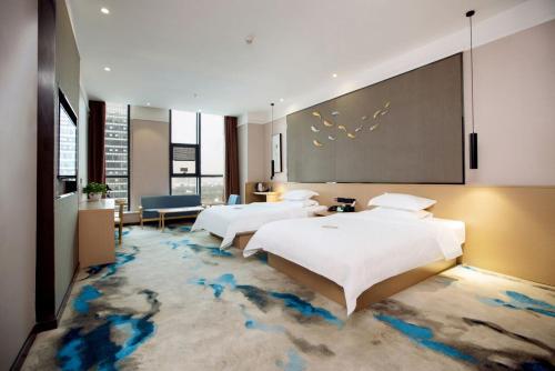 Imagen de la habitación del Hotel 海菲酒店 郑州高铁东站CbD国际会展中心店. Foto 19