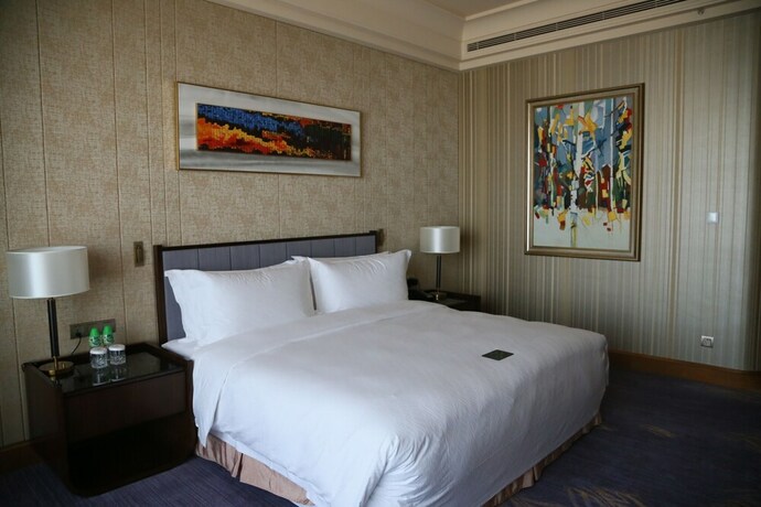 Imagen de la habitación del Hotel Chateau Star River Qing Dao. Foto 15