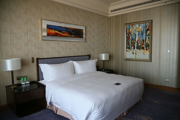 Imagen de la habitación del Hotel Chateau Star River Qing Dao. Foto 19