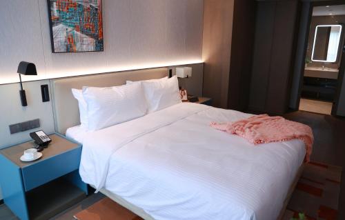 Imagen de la habitación del Hotel Citadines Jinqiao Building Yantai. Foto 16