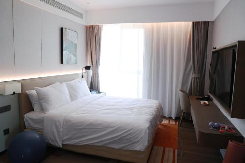 Imagen de la habitación del Hotel Citadines Jinqiao Building Yantai. Foto 17