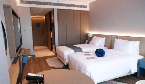 Imagen de la habitación del Hotel Citadines Jinqiao Building Yantai. Foto 19