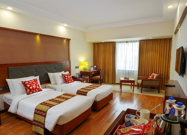 Imagen de la habitación del Hotel Classic Sarovar Portico Trivandrum. Foto 11