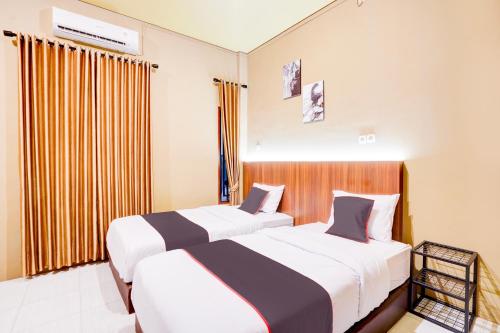 Imagen de la habitación del Hotel Collection O Padang City Center Near Transmart Padang Formerly De Orchids. Foto 20