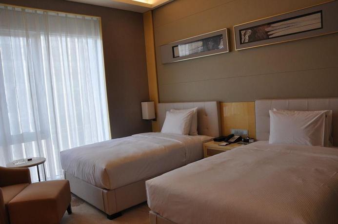 Imagen de la habitación del Hotel Conrad Dalian. Foto 4