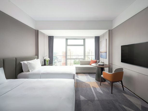 Imagen de la habitación del Hotel Cordis Shanghai Seaworld. Foto 10
