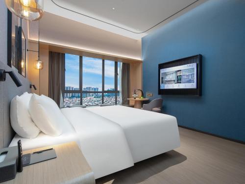 Imagen de la habitación del Hotel Country Inn & Suites by Radisson Dongfu Plaza. Foto 18