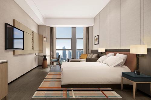 Imagen de la habitación del Hotel Courtyard by Marriott Nanning Wuxiang. Foto 13