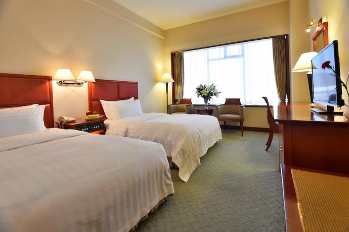 Imagen de la habitación del Hotel Dalian East. Foto 15