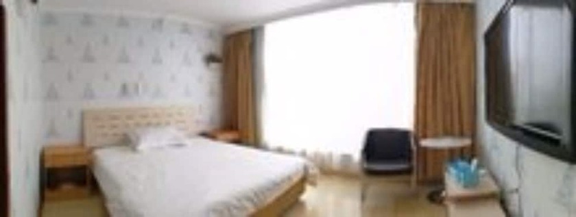 Imagen de la habitación del Hotel Dalian Venus Apartment. Foto 13