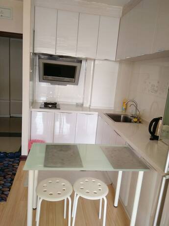Imagen de la habitación del Hotel Dalian Xiuzhu Building Apartment. Foto 17