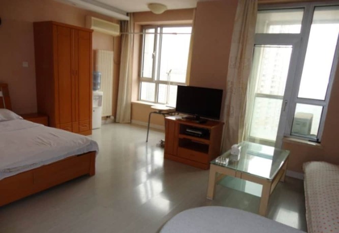 Imagen de la habitación del Hotel Dalian Xiuzhu Building Apartment. Foto 20