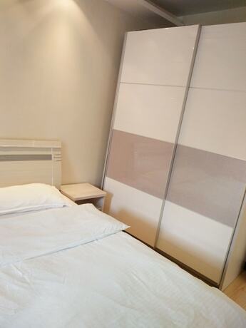 Imagen de la habitación del Hotel Dalian Xiuzhu Building Apartment. Foto 24