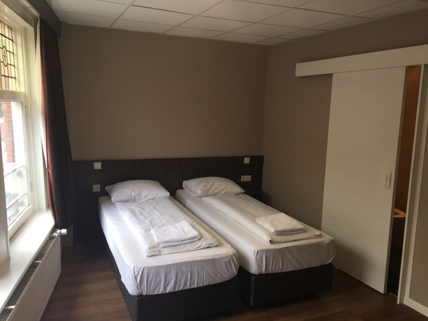 Imagen de la habitación del Hotel Damrak-Inn. Foto 4