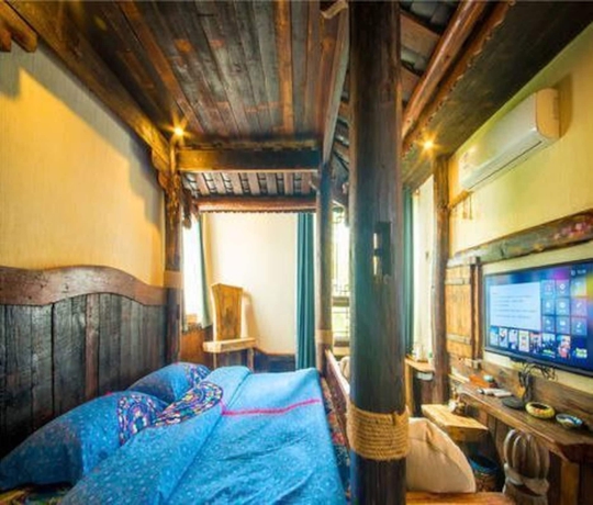 Imagen de la habitación del Hotel Dielianhua Cowherd Inn Zhangjiajie. Foto 15