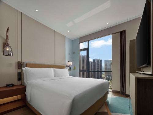 Imagen de la habitación del Hotel Doubletree By Hilton Yantai Golden Coast & Suites. Foto 18
