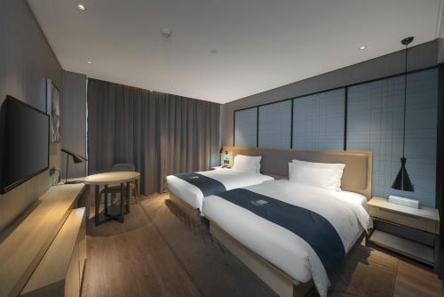 Imagen de la habitación del Hotel Echarm Haikou Zhongshan South Road East High Speed Railway Station. Foto 16