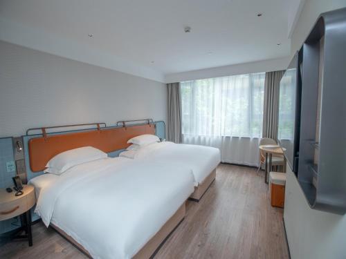 Imagen de la habitación del Hotel Echarm Qingyuan Qingcheng Station Municipal Government Shop. Foto 15