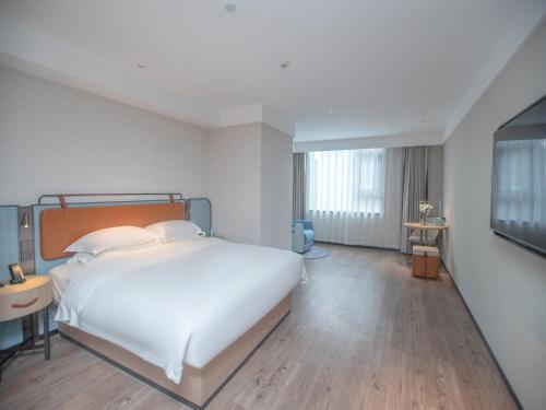 Imagen de la habitación del Hotel Echarm Qingyuan Qingcheng Station Municipal Government Shop. Foto 16