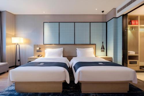 Imagen de la habitación del Hotel Echarm Wuhan Guanggu Biology City. Foto 12