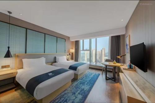 Imagen de la habitación del Hotel Echarm Wuhan Hanyang Wangjiawan Sixin Avenue Metro Station. Foto 16