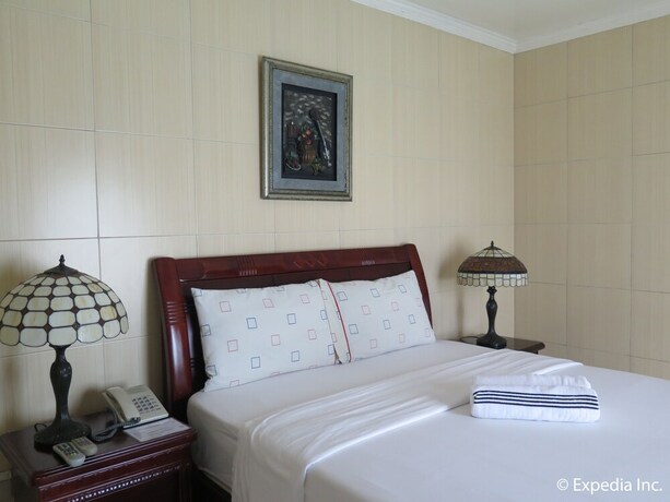 Imagen de la habitación del Hotel Emiramona Garden Hotel. Foto 8