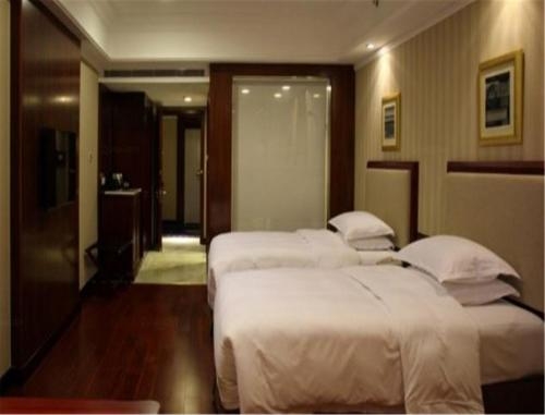 Imagen de la habitación del Hotel Enrichee Gloria Plaza Qingdao. Foto 7