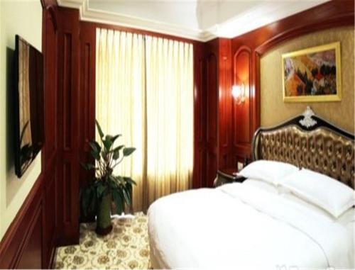 Imagen de la habitación del Hotel Enrichee Gloria Plaza Qingdao. Foto 9